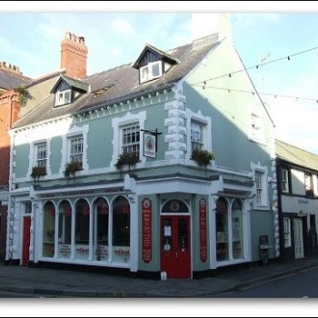 Corner shop - 3 storey blue with white corner stones and two dormers