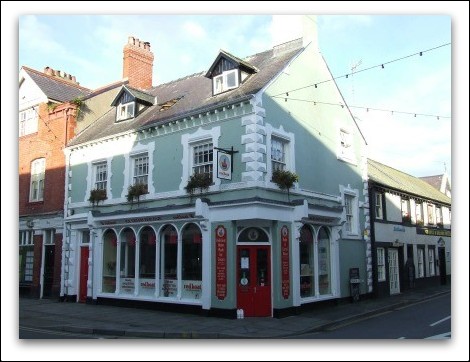 Corner shop - 3 storey blue with white corner stones and two dormers